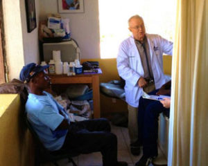 Dr. Brautigam sees a patient in the clinic.  He and one other family physician saw over 100 patients a day.  The gentleman looking on is a translator.  He was actually a lot more helpful than he appears to be in this picture!